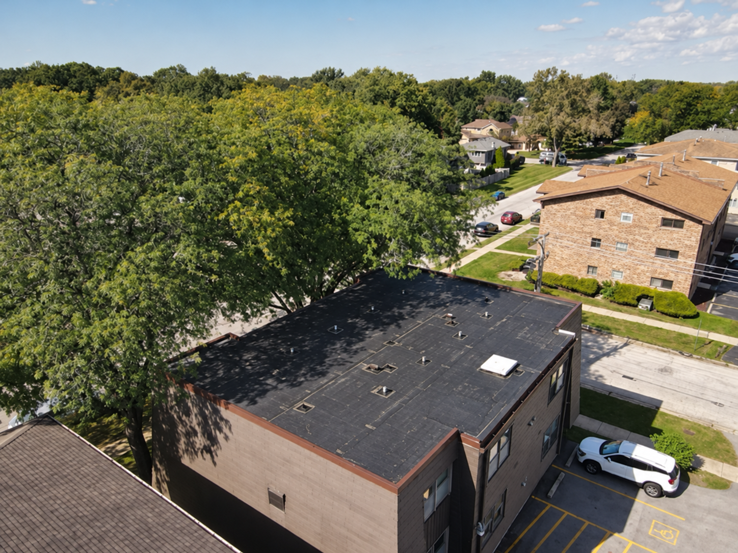 High aerial view of the Midlothian project roof and surrounding property